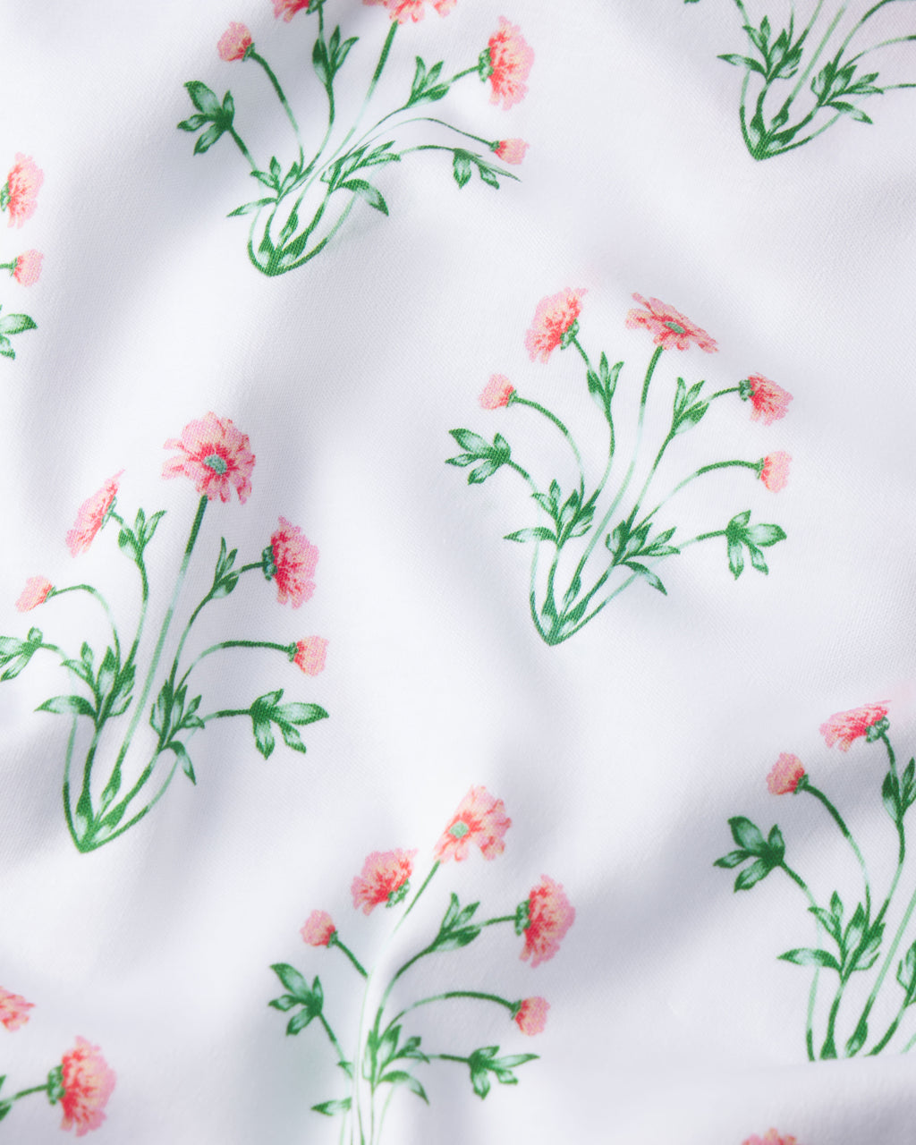 The Pima Short Robe in Sunkissed Coral Tropical Bouquet features soft white Pima cotton adorned with delicate coral pink flowers and green leaves, creating a spring-like, textured floral design.