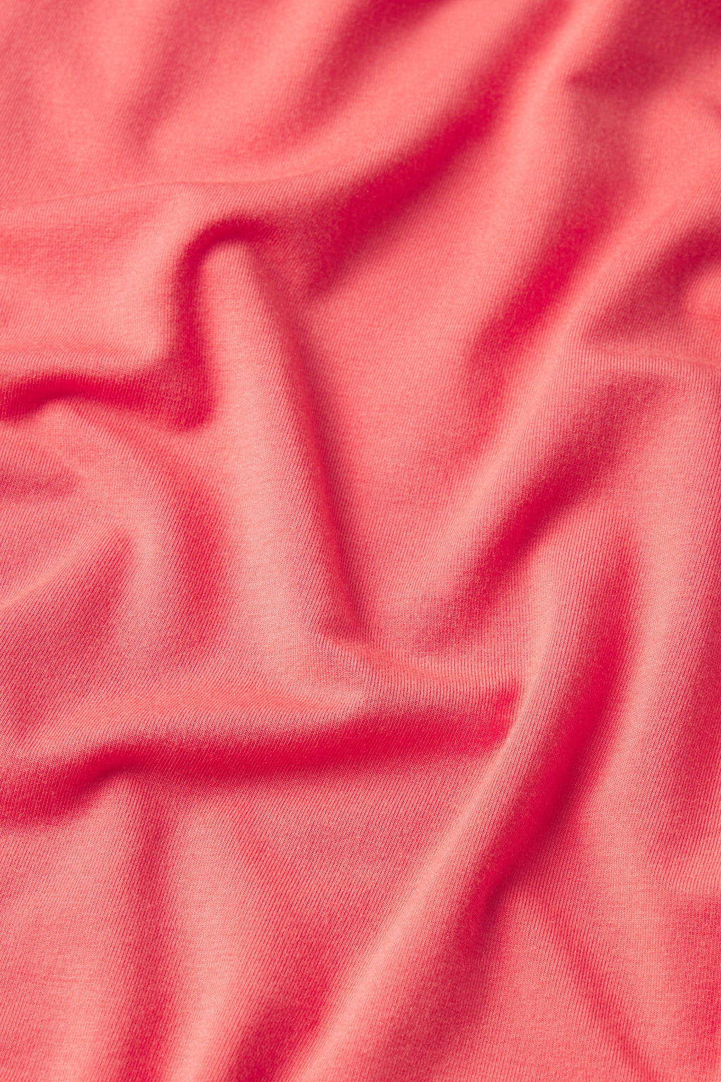A close-up of soft, light pink fabric with gentle folds reveals the textured surface of the DreamModal Ribbon Short-Long Set in Terrace.