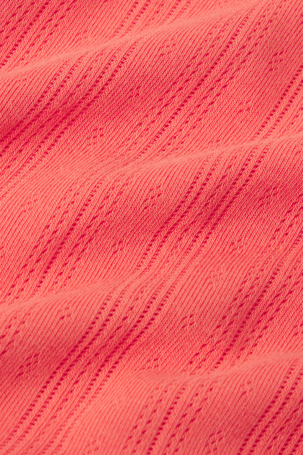 Terrace-colored pointelle knit fabric with vertical ribbed texture and eyelet pattern detail.