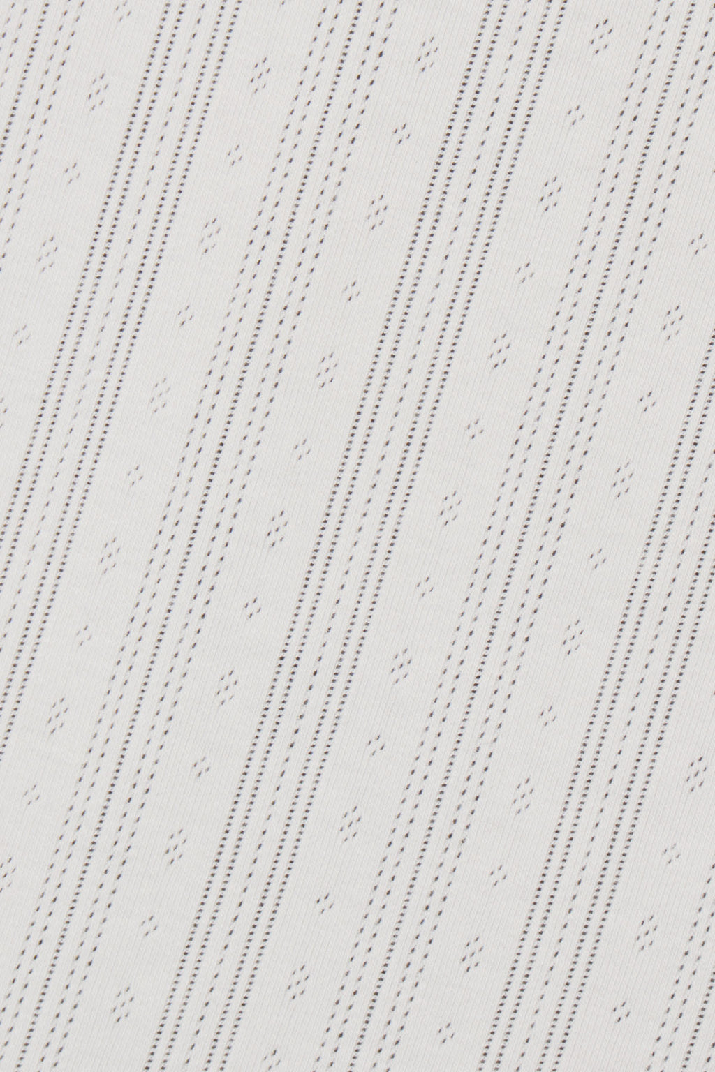 White pointelle fabric with diagonal striped pattern of small perforated holes.