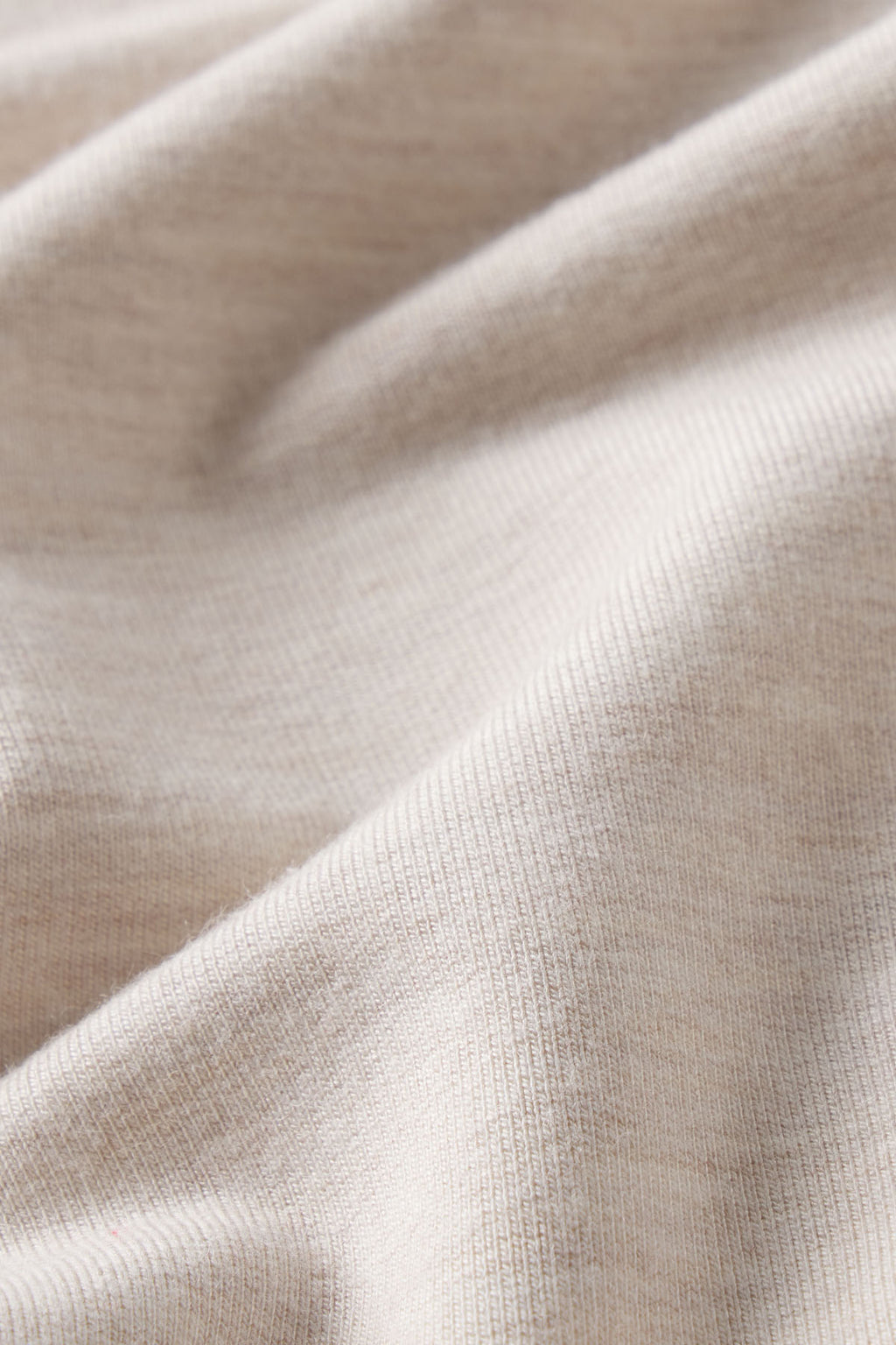 A close-up of the Relax Short Sleeve Shorts Set in Oat Heather, featuring beige ribbed modal spandex fabric with soft folds, fine lines, and gentle shadows for a textured look perfect for loungewear.