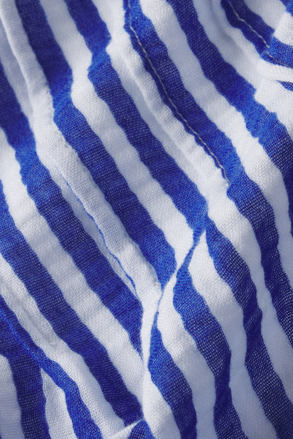 Blue and white striped gauze fabric with diagonal texture weave.