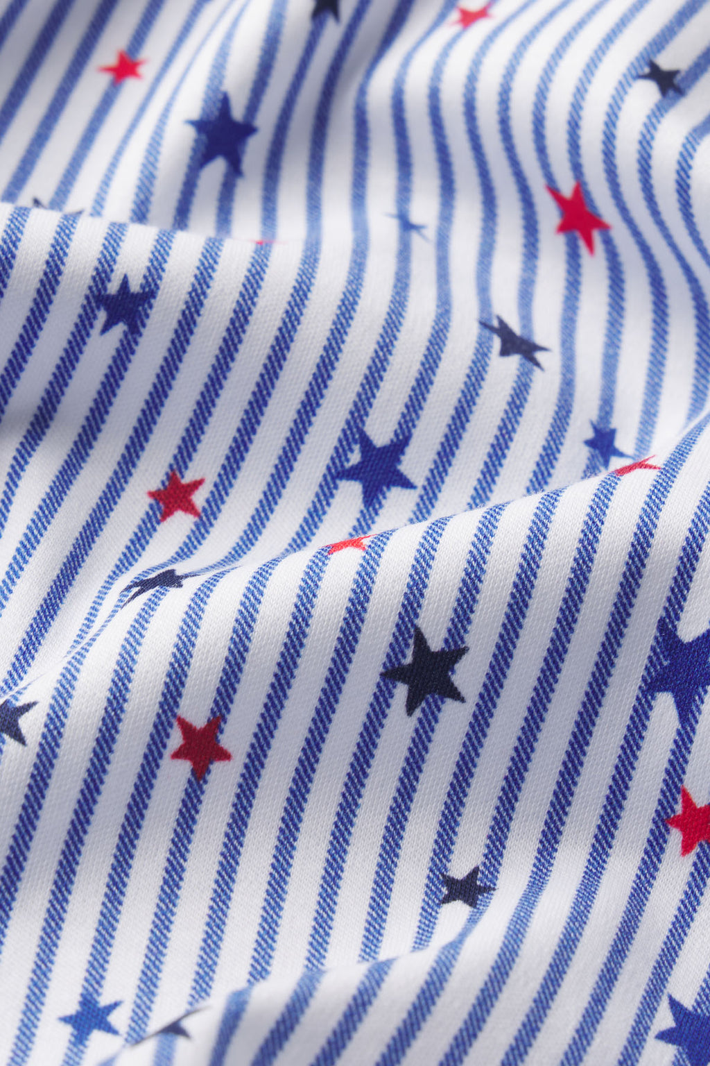 White and blue striped fabric with red and navy stars throughout.