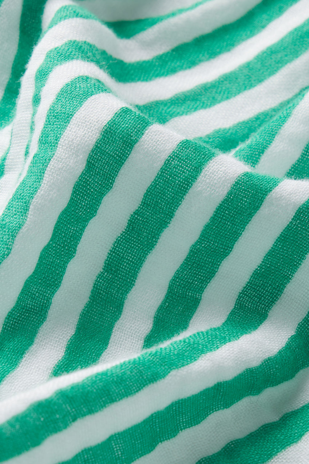 Close-up of the Hamptons Pants Set in Jadeite Stripe Gauze, highlighting the green and white horizontal stripes, soft texture, and gentle folds in the fabric.