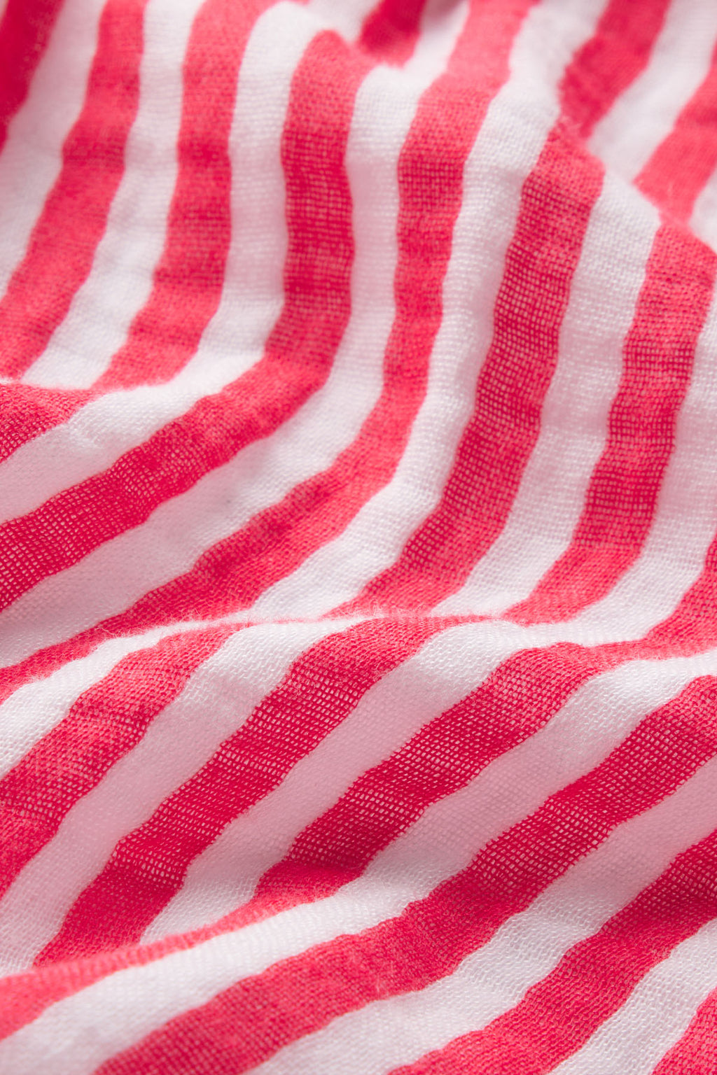 Close-up of the Hamptons Shorts Set in Bougainvillea Stripe Gauze, featuring soft pink and white striped fabric with gentle folds—perfect for comfortable sleepwear in warm weather.