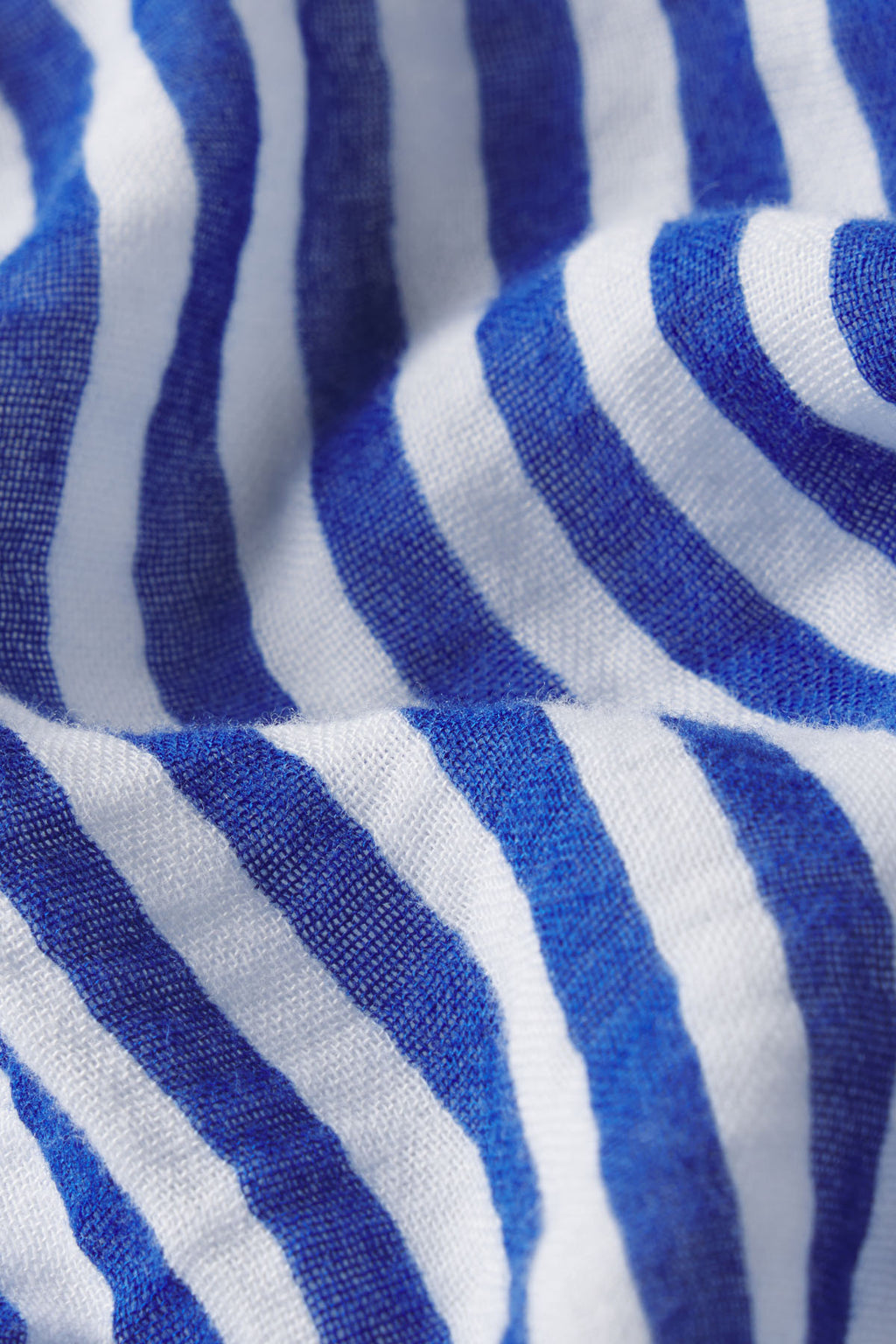 Close-up of the Lapis Stripe Gauze fabric on the Hamptons Nightgown, featuring blue and white horizontal stripes. The soft, breathable material with gentle wrinkles is perfect for hot sleepers and lovers of coastal-inspired styles.