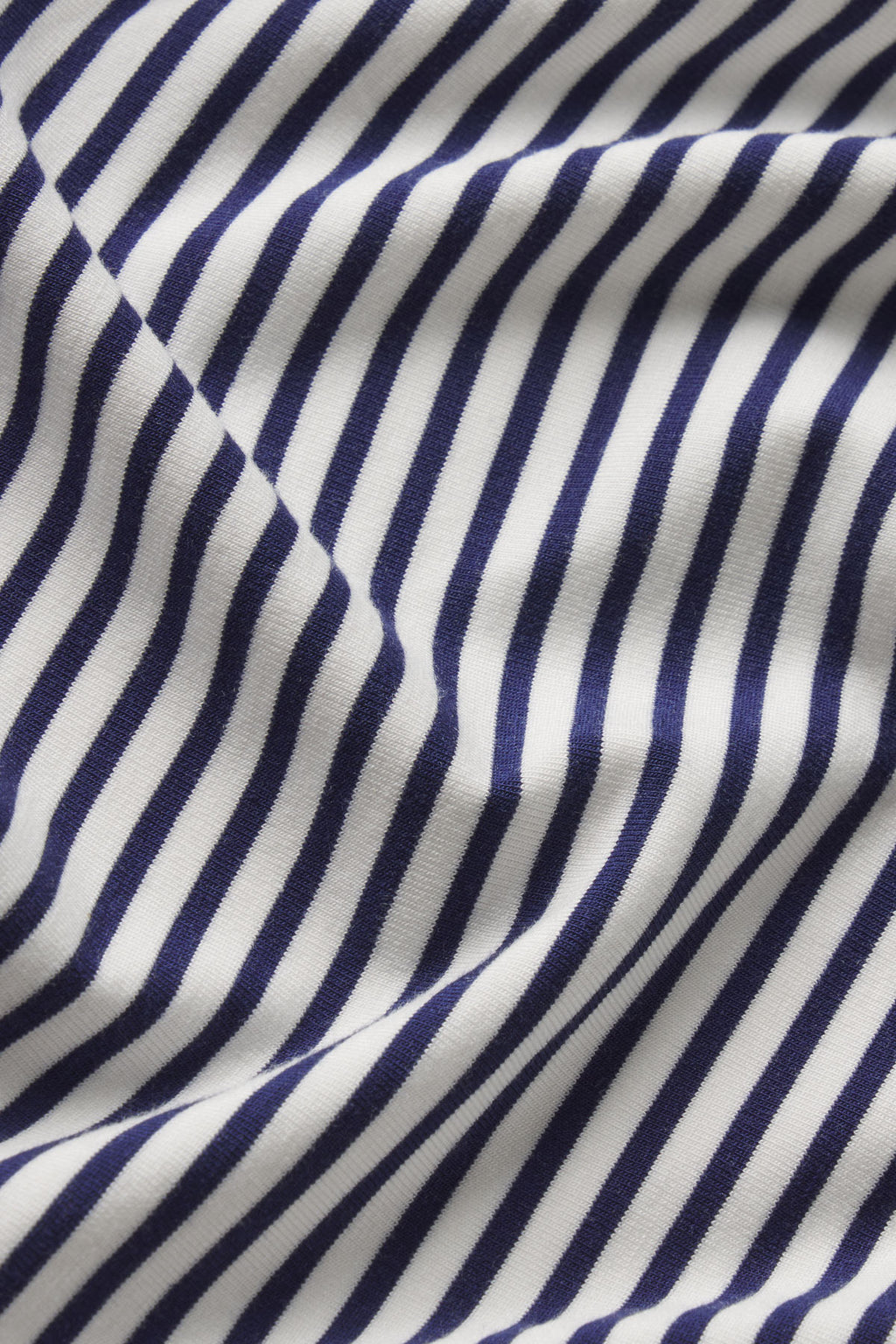 Navy and white diagonal pencil stripe fabric with a soft, textured surface.