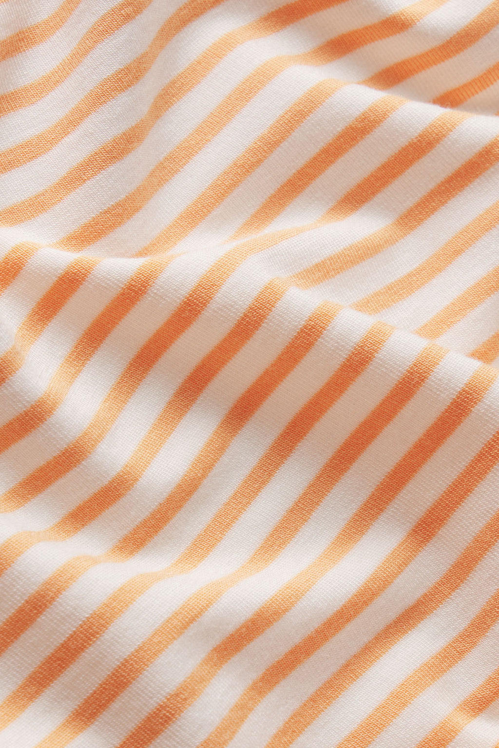 Marigold and white diagonal striped fabric with textured weave pattern.