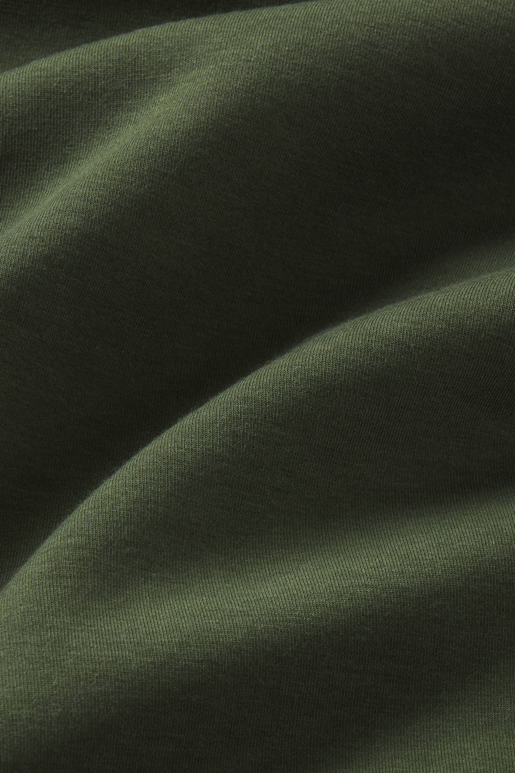 Cedar green ribbed fabric with draped folds showing texture and depth.