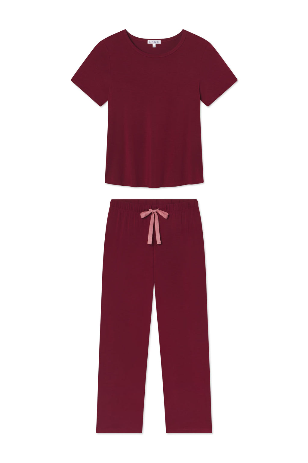 The DreamModal Ribbon Short-Long Set in Burgundy includes a short-sleeve maroon top and drawstring pajama pants with a pink ribbon tie at the waist.