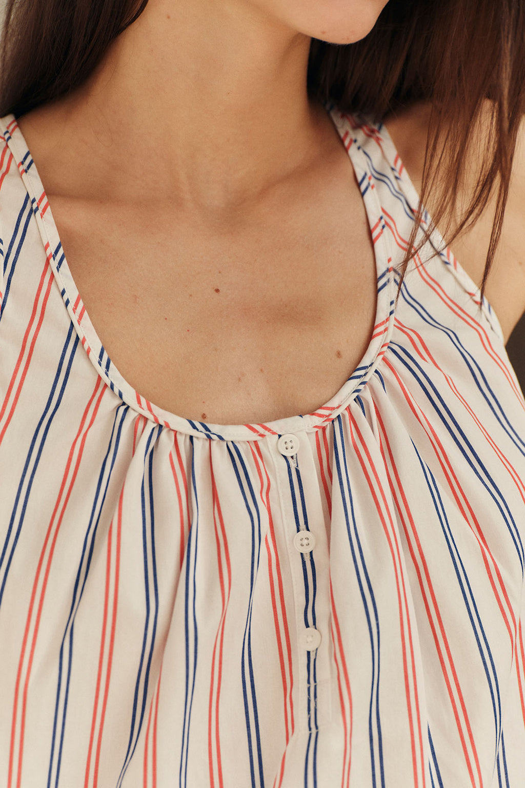 Nightgown with red, navy and cream vertical stripes, round neckline, and button front closure.
