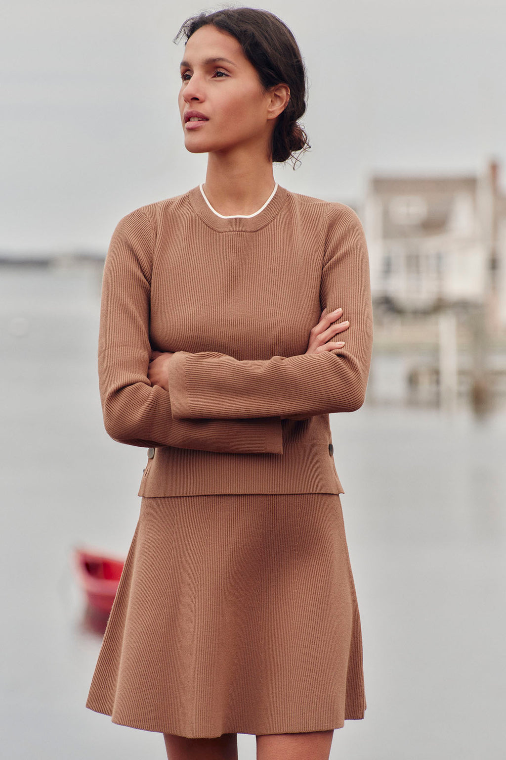 Toffee-colored ribbed knit set with long-sleeve crew neck top and A-line skirt with white trim.