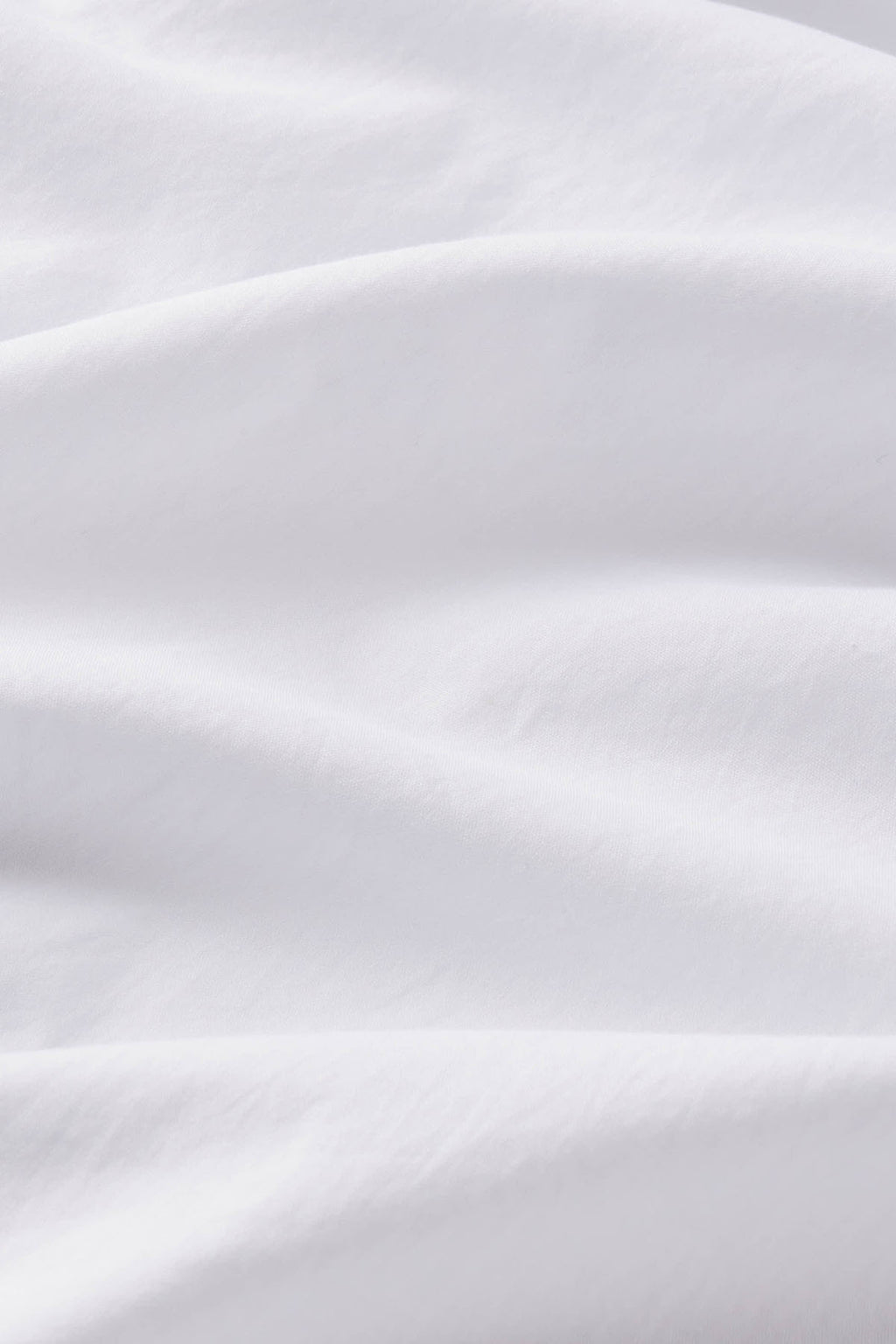 White fabric with soft folds and draping detail.