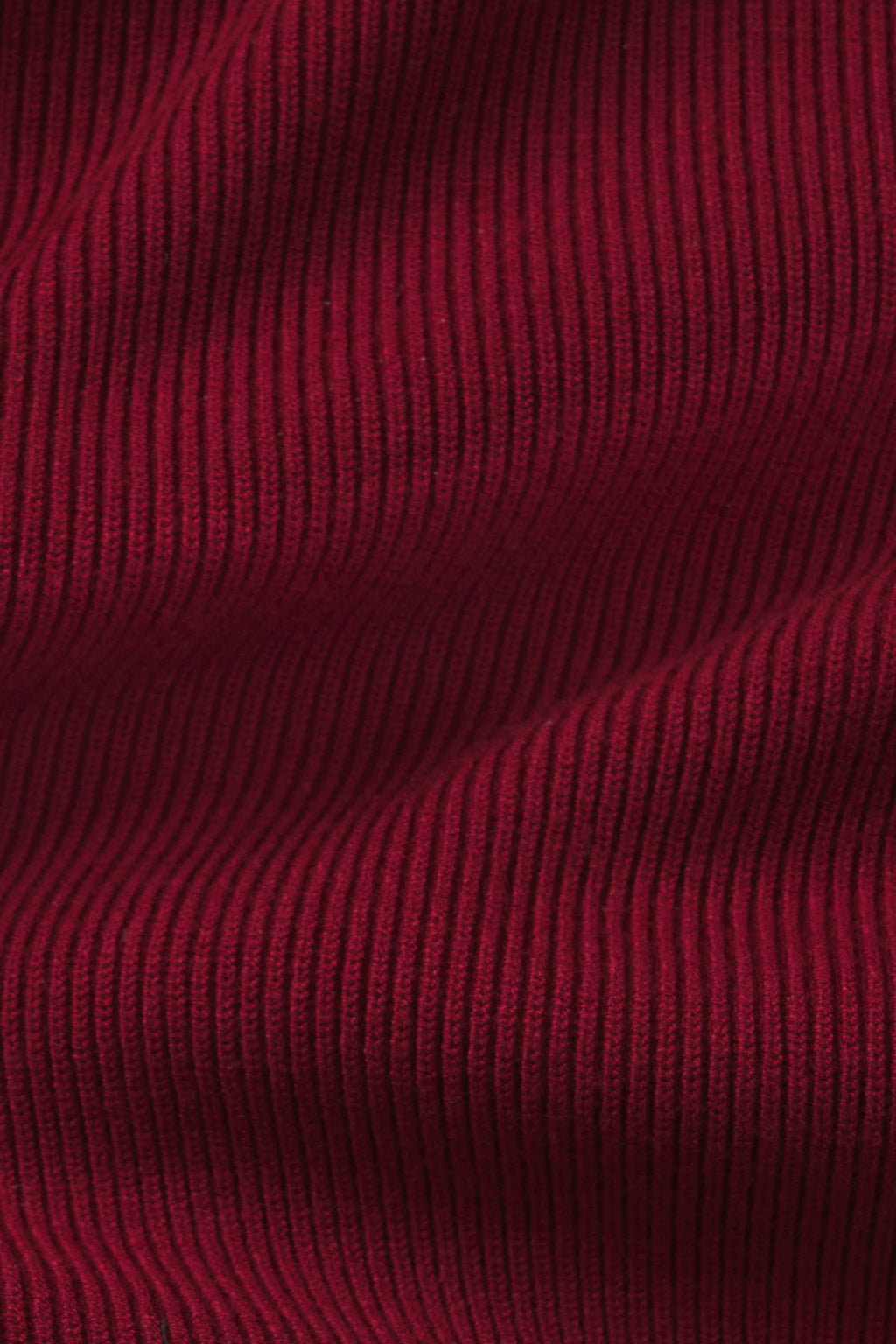 Deep burgundy ribbed fabric with vertical texture detail.