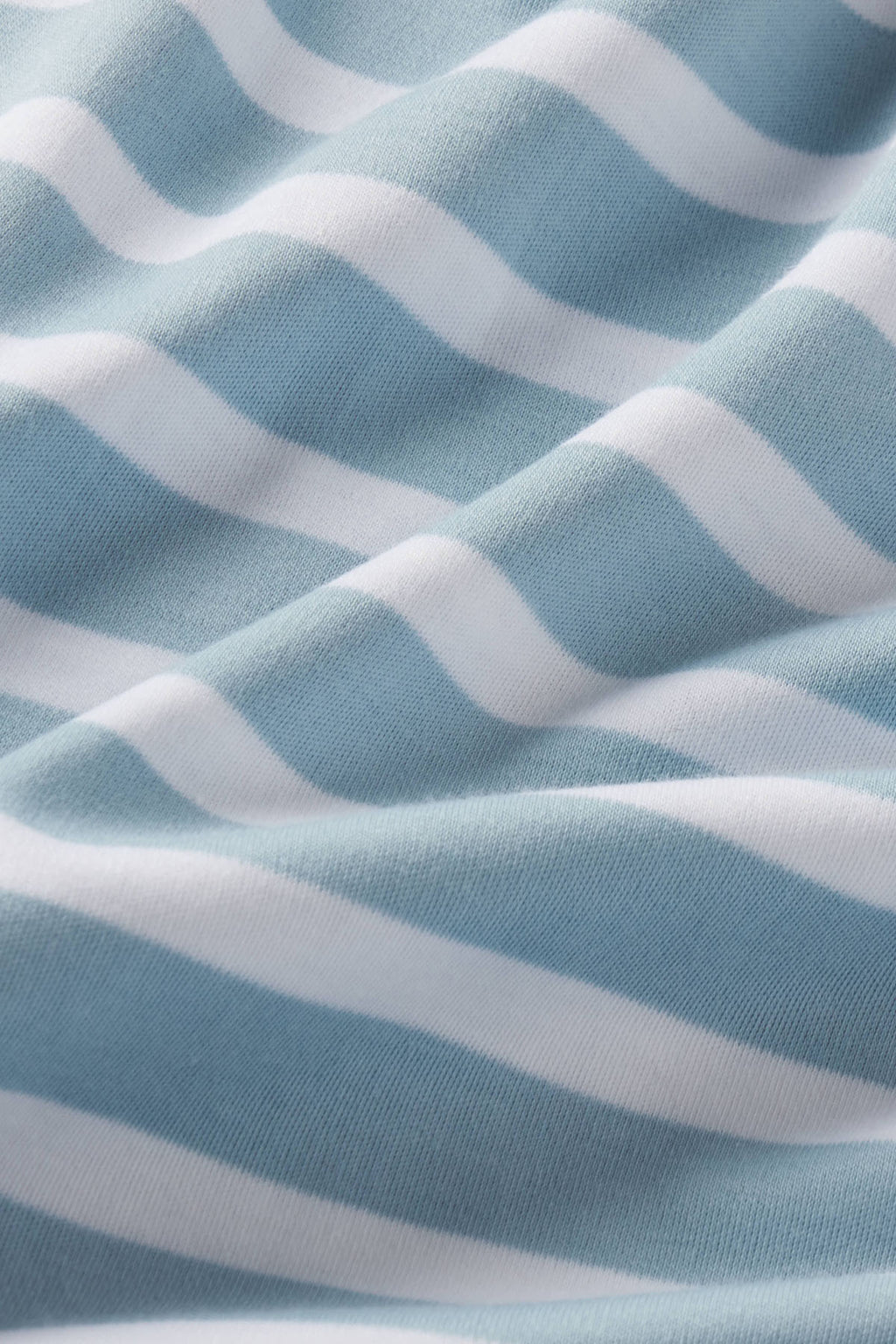Blue and white striped Pima cotton fabric with diagonal wave pattern texture.