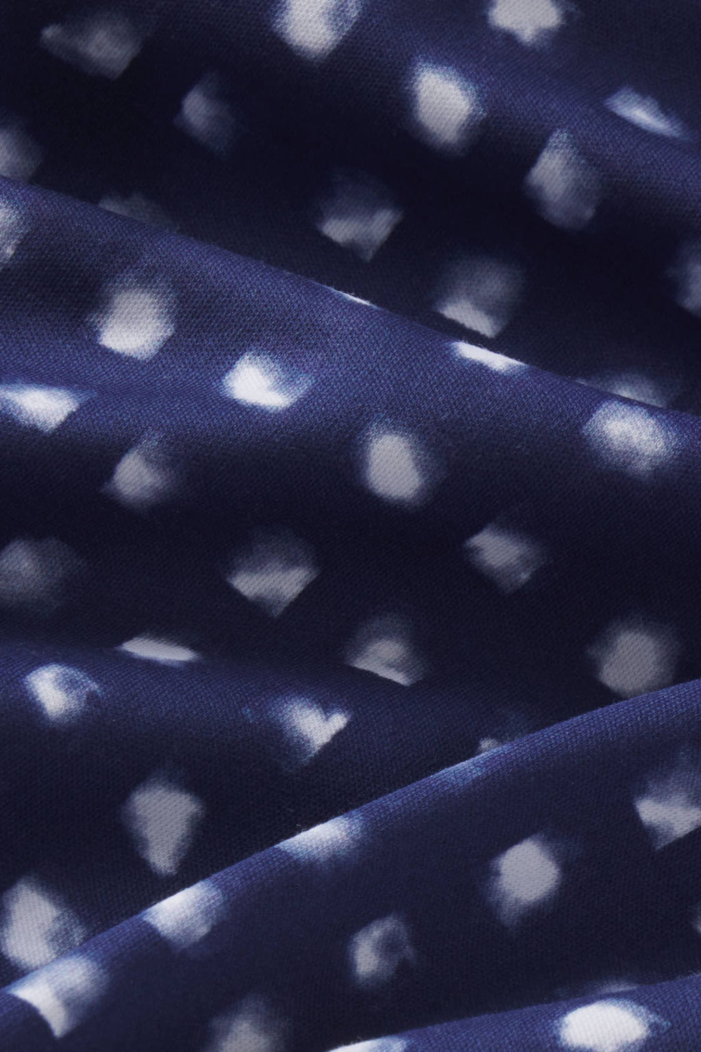 Dark blue fabric with white brushed check pattern and textured weave surface.