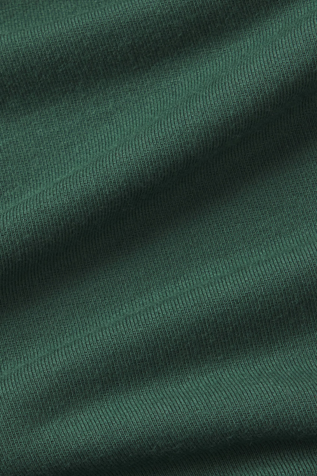 Close-up of trekking green ribbed knit fabric with soft draping texture.