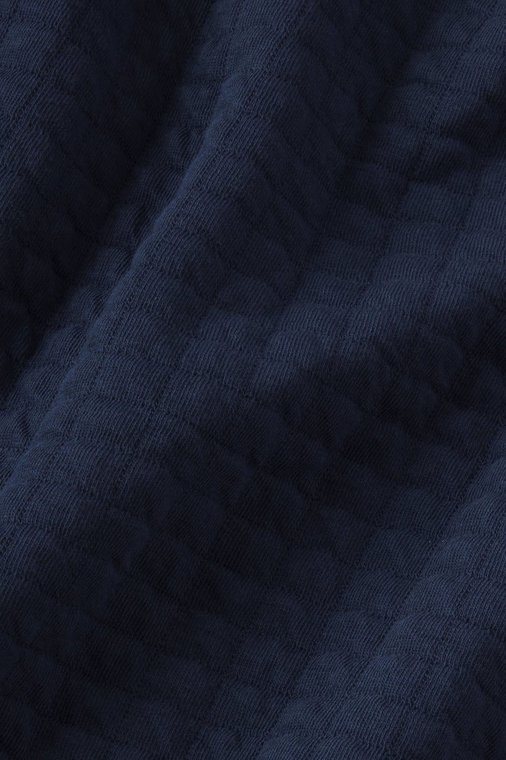 Dark navy textured fabric with ribbed surface pattern.