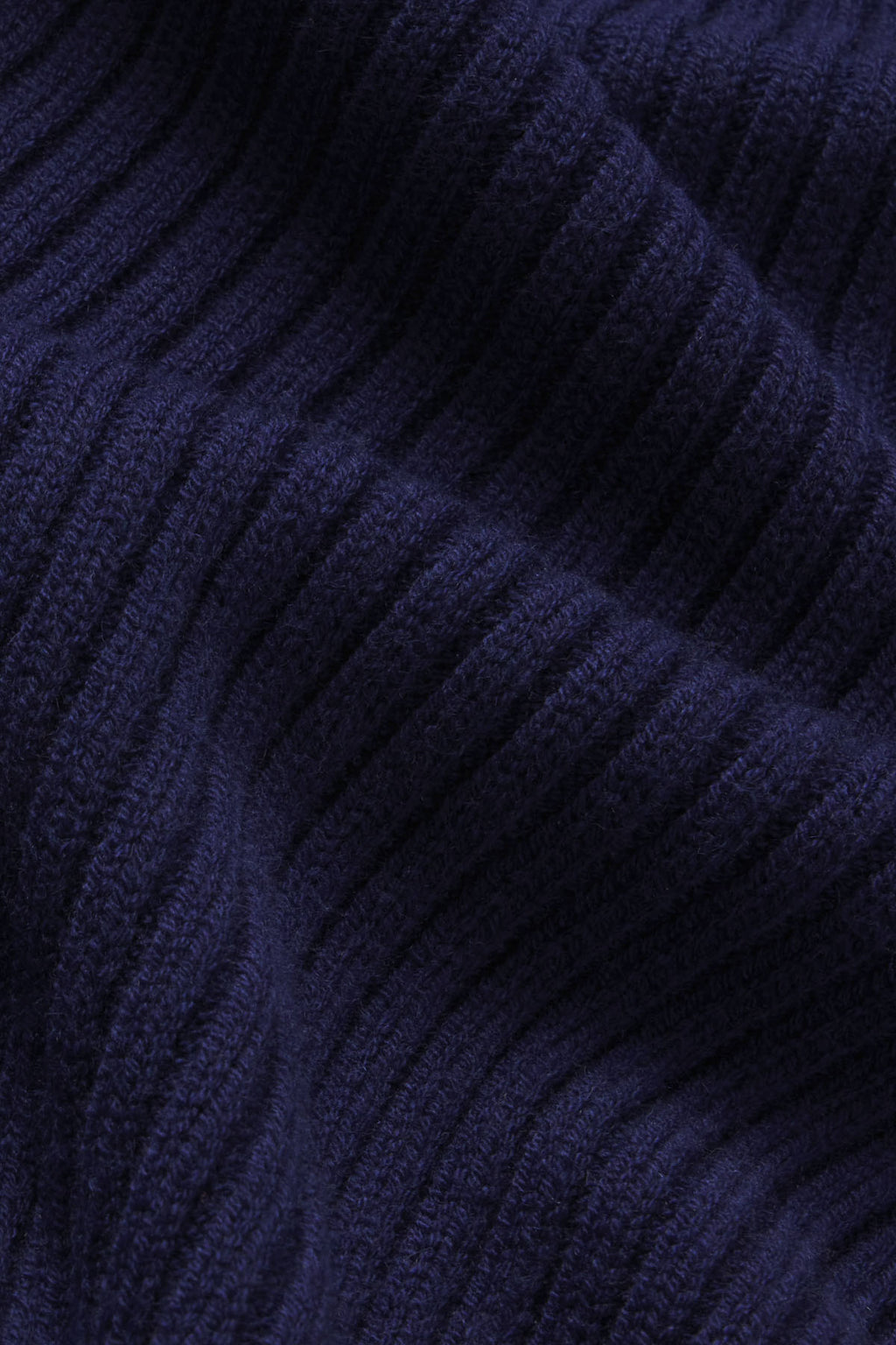 Dark navy ribbed knit fabric with vertical textured pattern.