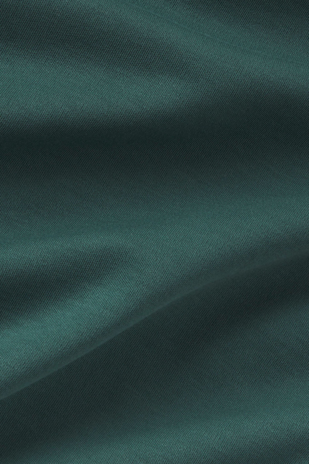 Trekking green textured knit fabric with diagonal weave pattern and subtle folds.
