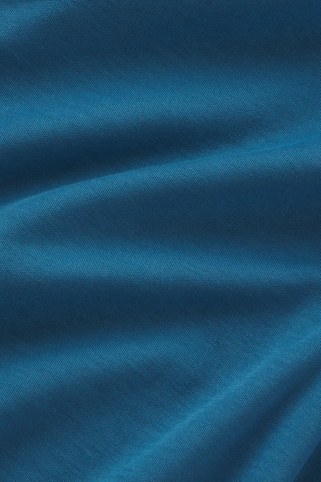 Haven blue knit fabric with diagonal ribbed texture and natural fold shadows.