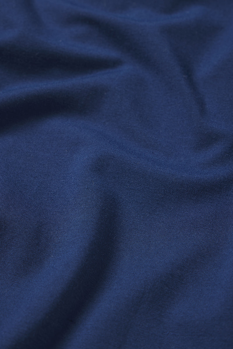 A close-up of Mens Bamboo Lounge Pants in Navy highlights the soft texture, fine knit details, and subtle shadows across the smooth fabric.