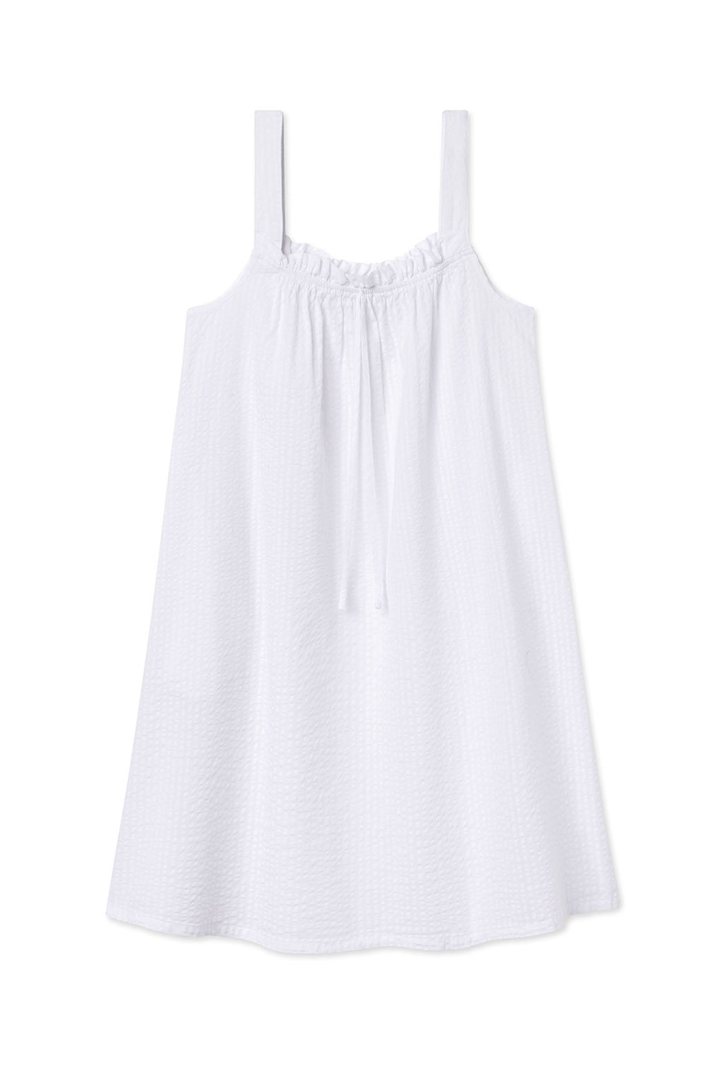The Alice Nightgown in White Seersucker is a sleeveless, lightweight dress with thick straps, a gathered tie neckline, and a loose, flowy fit—evoking the classic nightgown style.