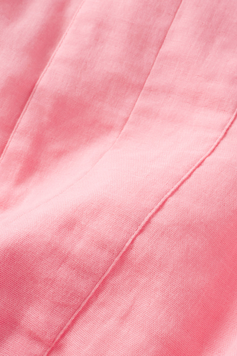 Close-up of the Gauze Caftan in Coral, made from 100% cotton fabric with visible stitching and seams, showing a smooth texture and subtle folds.